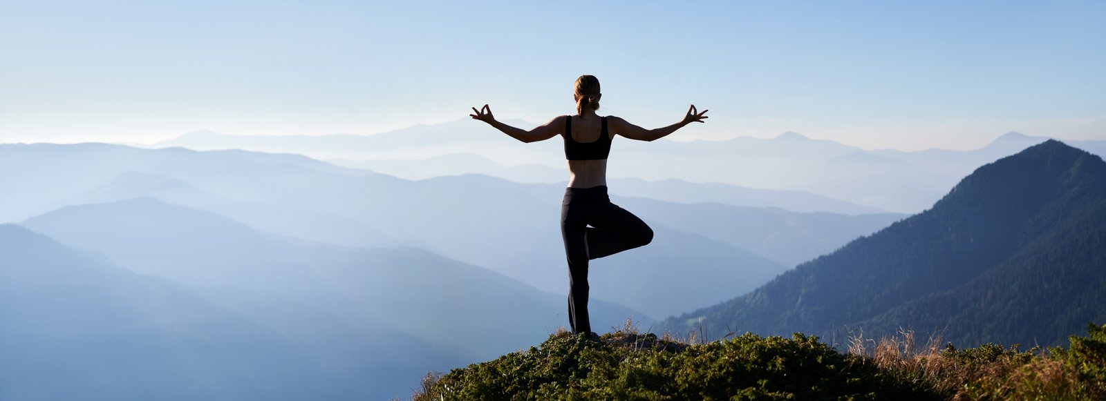 Yoga practice in a peaceful sunlit landscape